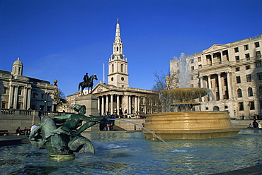 Water fountains, statues and architecture of Trafalgar Square, including St. Martin in the Fields, London, England, United Kingdom, Europe