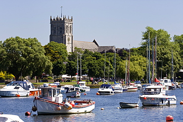 Christchurch Priory and pleasure boats on the River Stour, Dorset, England, United Kingdom, Europe