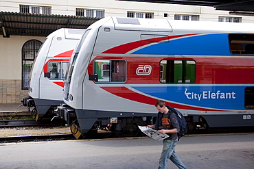 Two Elefant, double-decker inter-city trains, at Masarykovo Nadrazi Station with a man walking past, Prague, Czech Republic, Europe