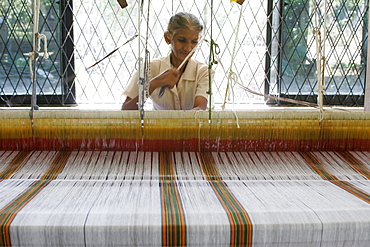 A woman working at a loom weaving textile, Beruwala, Sri Lanka, Asia