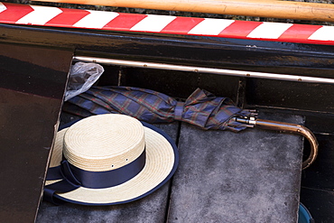 A gondolier's straw hat and umbrella on a gondola, Venice, Veneto, Italy, Europe