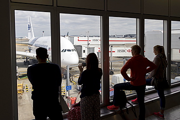 People looking through a window at an Airbus A380 of Malaysia Airlines at Kuala Lumpur International Airport, Malaysia, Southeast Asia, Asia