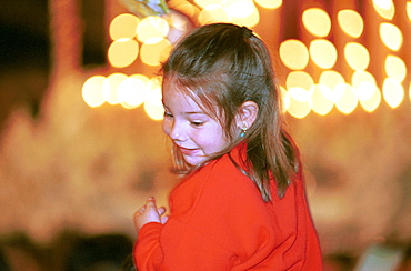 Malaga-Spain - Easter Week (Semana Santa) -A girl held shoulder-high as candle-lit floats pass by