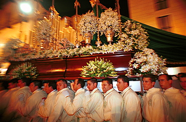 Malaga-Spain - Easter Week (Semana Santa) -Members of a brotherhood strain to carry a float 