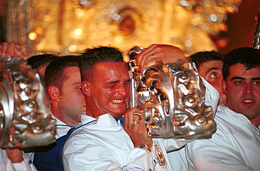 Malaga-Spain - Easter Week (Semana Santa) - Members of a brotherhood carry a float in procession 