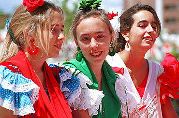 Seville - Spain - The Feria de Abril - Seville Fair -  girls in traditional costume enjoying the fair