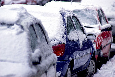Street scene with snow on cars at dusk during winter, England, United Kingdom, Europe