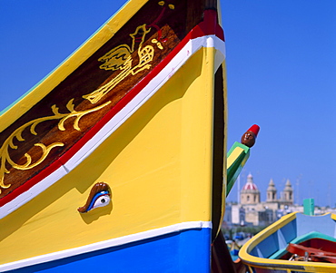 Close-up of a painted fishing boat with eye motif in the harbour at Marsaxlokk, Malta 