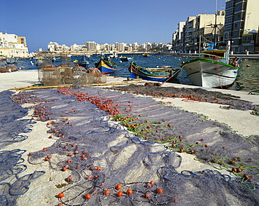 Fishing nets drying in the sun in St. Julians Bay, Malta, Mediterranean, Europe