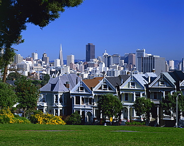 Old houses known as the Painted Ladies on Steiner Street, with the city skyline in the background, in San Francsico, California, United States of America, North America