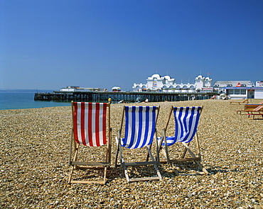 Empty deck chairs on the beach and the Southsea Pier, Southsea, Hampshire, England, United Kingdom, Europe