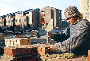 Brick laying on housing construction site