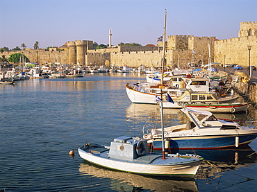 Moored fishing boats and the harbourside fortifications in the old town, Rhodes Town, Rhodes, Dodecanese Islands, Greek Islands, Greece, Europe