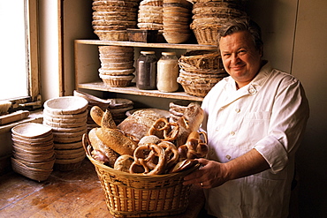 Baker with selection of bread, France, Europe