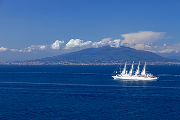 Mount Vesuvius from across the Bay of Naples with Wind Surf cruise ship in foreground, Campania, Italy, Europe