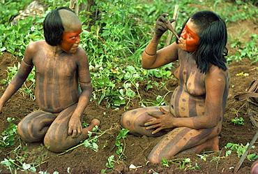 Portrait of a Xingu woman and child with body decoration in Brazil, South America