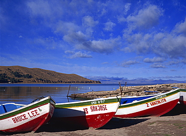 Three fishing boats pulled onto shore of Lake Titicaca, Copacabana, Bolivia, South America