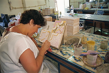 Woman painting on tiles, Sant'Ana azulejos factory, Lisbon, Portugal, Europe