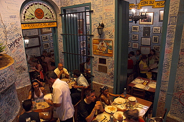 La Bodeguita del Medio restaurant, with signed walls and people eating at tables, Habana Vieja, Havana, Cuba, West Indies, Central America