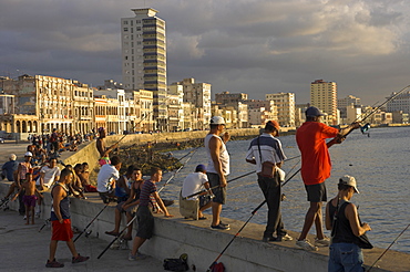 Men fishing at sunset, Avenue Maceo, El Malecon, Havana, Cuba, West Indies, Central America