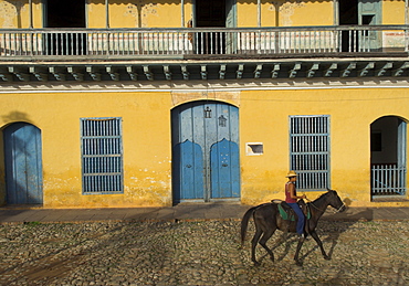 Man riding horse past the Galeria del Arte (Art Gallery), Plaza Mayor, Trinidad, UNESCO World Heritage Site, Cuba, West Indies, Central America