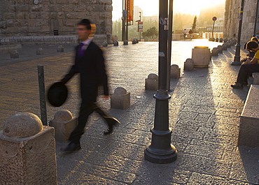 Young orthodox Jew dressed for the Sabbath prayers walking to the Western Wall at sunset, Jaffa Gate, Old City, Jerusalem, Israel, Middle East