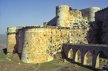 view from outside with towers moat and stone bridge, crac des Chevaliers, Qala'at Al Hosn, Syria