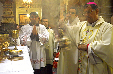 Monseigneur Fouad Boutros Tawal, Coadjutor of the Latin Patriarch of Jerusalem, swinging incense during Mass in Easter week, Church of the Holy Sepulchre, Old City, Jerusalem, Israel, Middle East