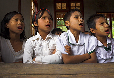 Group of school children reciting lessons in new school building built by local NGO, village of Thit La, Shan State, Myanmar (Burma), Asia