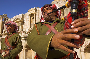 Two Jordanian soldiers in traditional dress playing the bagpipes and drum, South Theatre, Jerash, Jordan, Middle East