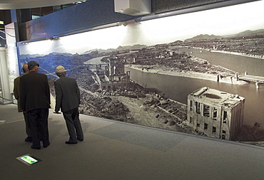 Visitors looking at huge wall poster showing the destruction of the city after the atomic bomb of 6th August 1945, Peace Memorial Museum, Peace Memorial Park, Hiroshima, Honshu, Japan, Asia