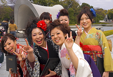 Group of female students in kimonos laughing at the camera, Cenotaph, Peace Memorial Park for atomic bomb of 1945, Hiroshima, Honshu, Japan, Asia