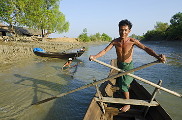 Fisherman on his small boat, Yin Dee Lag village, Irrawaddy delta, Myanmar (Burma), Asia