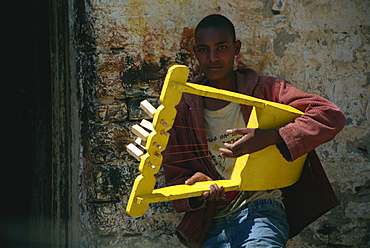 Boy playing handmade instrument, Mekele, Ethiopia, Africa