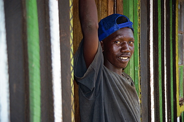 Boy standing in doorway, Meru, Kenya, East Africa, Africa