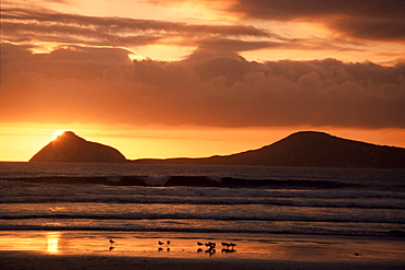 Sun sinks behind small islands, Wilson's Promontory National Park, Victoria, Australia, Pacific