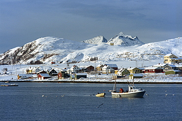 Fishing boat leaving harbour on Kvaloya Island, Arctic Norway, Scandinavia, Europe