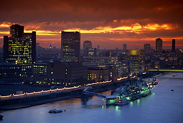 HMS Belfast moored on the Thames, illuminated at dusk, London, England, United Kingdom, Europe