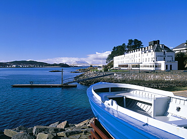 Boat and Lochalsh Hotel, with Skye bridge beyond and snow on the distant mountains of Skye in late winter, Kyle of Lochalsh, Highland region, Scotland, United Kingdom, Europe