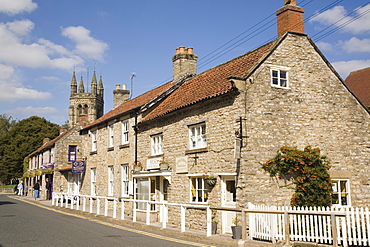 Traditional sandstone cottages and shops with tower of All Saints Church, Helmsley, edge of North York Moors National Park, North Yorkshire, England, United Kingdom, Europe