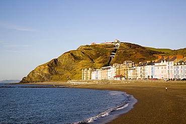 Colourful Victorian seafront buildings overlooking empty beach with funicular cliff railway on Constitution Hill in winter light, Aberystwyth, Ceredigion, Dyfed, Wales, United Kingdom, Europe