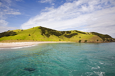 View back to Waewaetorea Island recreational reserve with sandy beach across clear green blue sea on Pacific coast, Bay of Islands, Northland, North Island, New Zealand, Pacific