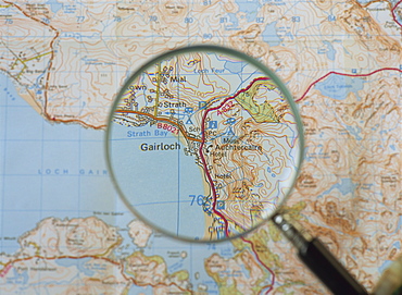 Magnifying glass above an Ordnance Survey map, Scotland, United Kingdom, Europe