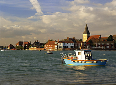 View across water at high tide, Bosham village and harbour, Sussex, England, United Kingdom, Europe