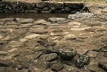 Drinking pool and decorated grinding stone at excavated site of pre-Columbian city, Guayabo National Monument, Turrialba, Costa Rica, Central America