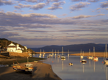 Boats in the evening sun at low tide on the Dovey Estuary, Aberdovey, Gwynedd, Wales, United Kingdom, Europe