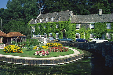 Swan Hotel on a bend in the River Coln, Bibury, Gloucestershire, The Cotswolds, England, United Kingdom, Europe