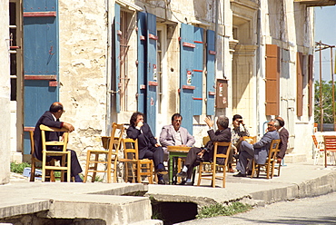 Men sitting outside on the pavement, putting the world to rights, one Sunday morning in Lefkara, Cyprus, Europe