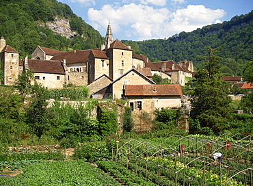 Man working in vegetable gardens below the village of Baume les Messieurs, in Franche-Comte, France, Europe