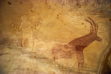 Huge painting of god figure and sable antelope on rock wall, Tassili Plateau, Algeria, North Africa, Africa